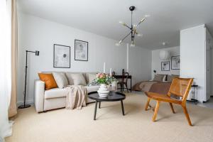 a living room with a couch and a table at Budget-friendly studio on Södermalm, construction work in Stockholm