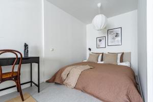 a bedroom with a bed and a desk and a chair at Budget-friendly studio on Södermalm, construction work in Stockholm