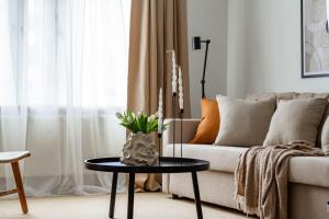 a living room with a couch and a table at Budget-friendly studio on Södermalm, construction work in Stockholm