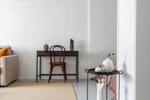a room with a table and a chair and a table with a stool at Budget-friendly studio on Södermalm, construction work in Stockholm