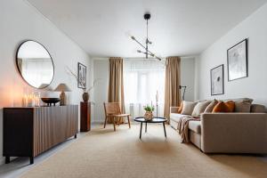 a living room with a couch and a table at Budget-friendly studio on Södermalm, construction work in Stockholm