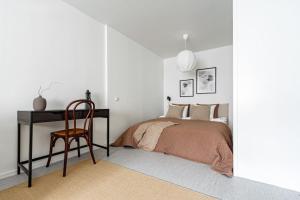 a bedroom with a bed and a desk and a chair at Budget-friendly studio on Södermalm, construction work in Stockholm