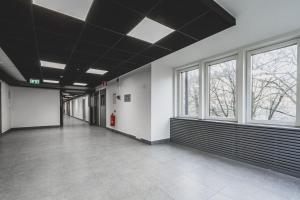 an empty hallway with windows and a fire hydrant at Budget-friendly studio on Södermalm, construction work in Stockholm