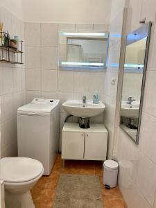 a white bathroom with a toilet and a sink at Ba Em City Apartment in Wiesbaden +37 photos