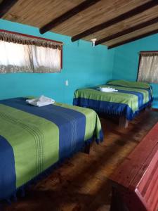 Postel nebo postele na pokoji v ubytování Cabañas Montebello