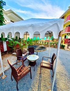 a group of chairs and a table under a tent at Sea breeze 1 bhk apartment A12 Calangute,North Goa in Nagoa-Bardez +21 photos