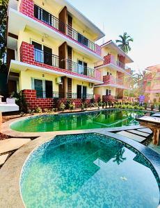 a large swimming pool in front of a building at Sea breeze 1 bhk apartment A12 Calangute,North Goa in Nagoa-Bardez
