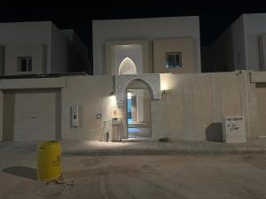 a building with an archway in a city at night at فيلا سعد in Riyadh