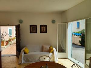 a living room with a couch and a table at Appartement Les Tilleuls in Olmi-Cappella +23 photos