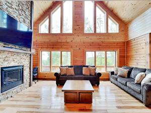 a living room with couches and a fireplace at Fortune Mountain Retreat in McHenry