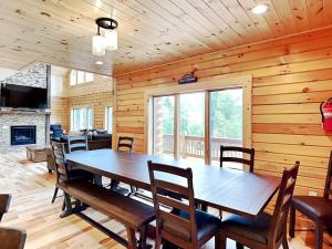 a dining room with a large wooden table and chairs at Fortune Mountain Retreat in McHenry