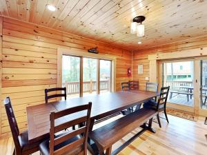 a dining room with a large wooden table and chairs at Fortune Mountain Retreat in McHenry