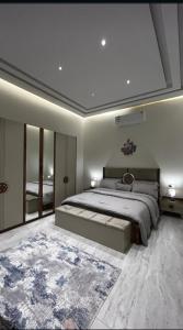 a bedroom with a large bed and a large mirror at شقه فاخره بجوار الراشد مول in Sīdī Ḩamzah