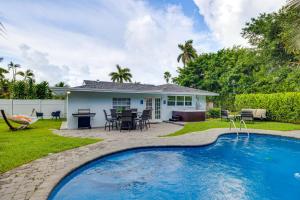 a house with a swimming pool in the yard at Pet-Friendly Gem with Pool and Yard in West Palm Beach in West Palm Beach