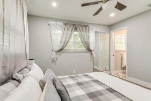 a bedroom with a bed and a ceiling fan at Pet-Friendly Gem with Pool and Yard in West Palm Beach in West Palm Beach