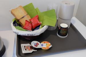 a small refrigerator with a sandwich and other food at Adriroomsrho in Rho
