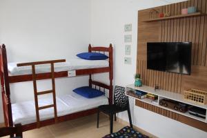 Ένα ή περισσότερα κρεβάτια σε δωμάτιο στο Casa simples, ampla e confortável a 5 min da praia