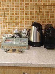 a coffee maker on a kitchen counter with a coffee pot at Thissio Hideaway Suite in Athens