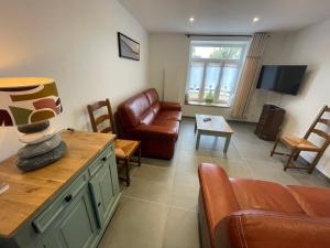 a living room with a couch and a chair at Wissant Maison Chez Jeanne in Wissant