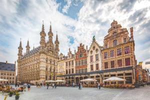 a city square with buildings and people walking around at Art Studio Leuven in Leuven