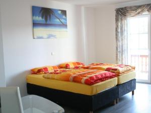 a large bed in a room with a window at Pension Prell in Düren - Eifel