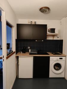 a kitchen with a washing machine and a washer at Studio dans résidence avec piscine à 50m de la mer in Roquebrune-Cap-Martin +6 photos
