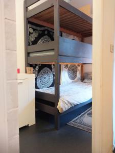 a bunk bed in a room with a bunk bed in a house at Studio dans résidence avec piscine à 50m de la mer in Roquebrune-Cap-Martin