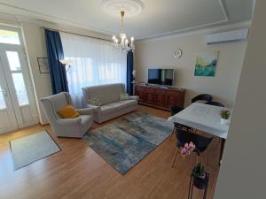 a living room with a couch and a table at Várnegyed Apartman in Dunaföldvár