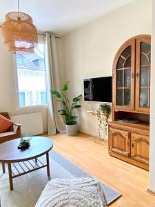 a living room with a coffee table and a tv at Ba Em City Apartment in Wiesbaden +37 photos