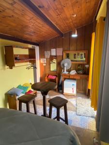 a room with a bed and a table and stools at B&B Sol Poente in Cunha +97 photos