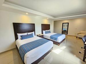 Postel nebo postele na pokoji v ubytování Hotel Maria Elena