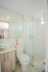 a bathroom with a toilet and a sink and a shower at Charming Decor & Stunning Views Green Poblado in Medellín