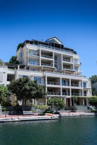 a large white building next to a body of water at 401 Apartment in Cape Town