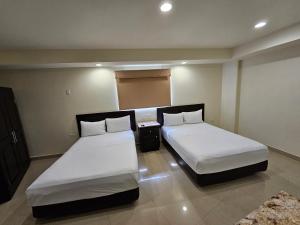 Postel nebo postele na pokoji v ubytování Hotel Maria Elena