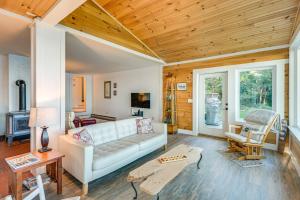 a living room with a couch and a table at Oceanfront Frenchman Bay Home Stunning View! in Marlboro
