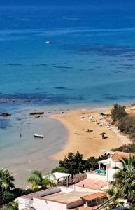 a view of a beach with a boat in the water at La Foggia seaside paradise in Siculiana