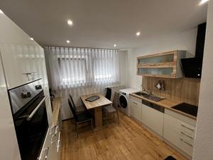a small kitchen with a table and a counter top at Ferienwohnung Manuela in Hausen im Tal