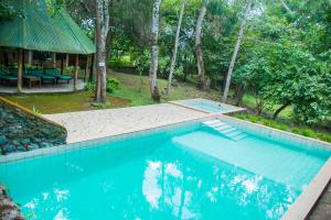 a swimming pool in the middle of a yard at Meru Mbega Lodge in Usa River