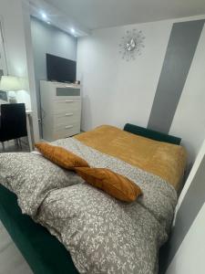 a bedroom with a bed with two pillows on it at Apartament Grabowa in Kłodzko