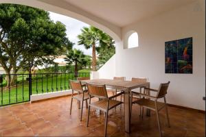 a dining room with a table and chairs at Alto Club, Alvor, Portugal in Alvor