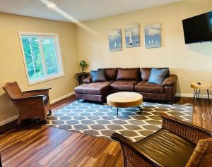 a living room with a couch and a tv at School Section Cottage Lake Access in Mecosta