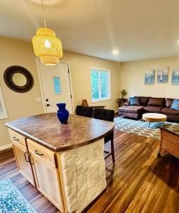 a kitchen and living room with a island in the middle at School Section Cottage Lake Access in Mecosta