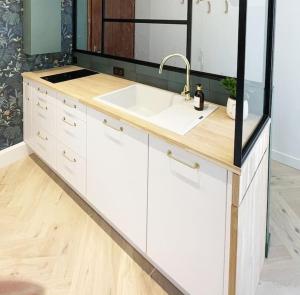 a bathroom with a sink and a mirror at La parenthèse in Cabourg