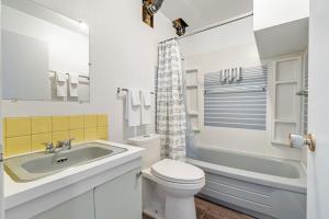 a white bathroom with a sink and a toilet at Timber Valley I HotTub I PingPong I Sleep 14 I BBQ in Drumheller +41 photos