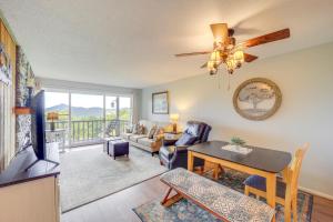 a living room with a couch a table and a ceiling fan at 1 Mi to Ski Lifts Sugar Mountain Condo in Sugar Mountain