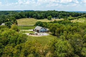 an overhead view of a house in a field with trees at 27 South - Large Lux Retreat With Hot Tub & Gameroom in Thompsons Station