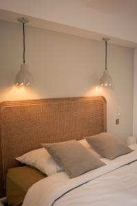 a bedroom with two lights above a bed at Mon cocon au cœur du village et des plages in Bandol +37 photos