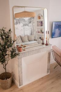 a mirror over a fireplace in a living room at Mon cocon au cœur du village et des plages in Bandol