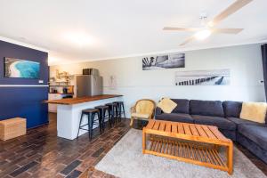 a living room with a couch and a table at Gone Coastal in Lancelin +6 photos