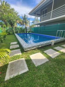 a swimming pool in the yard of a house at The City Edge in Vatuwangga